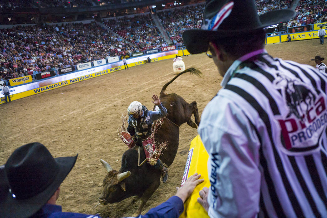 Trey Benton III competes in the bull riding event during the second night of the National Finals Rodeo at the Thomas & Mack Center in Las Vegas on Friday, Dec. 8, 2017. Chase Stevens Las Vegas ...