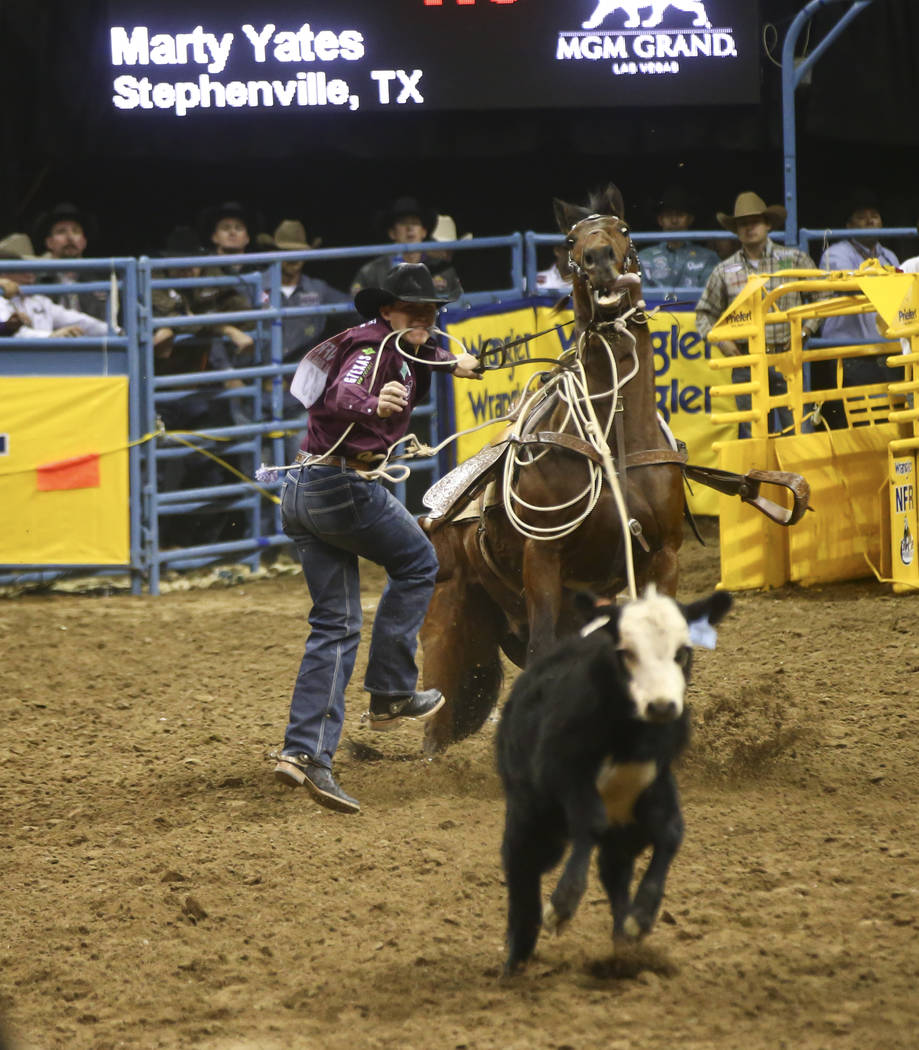 Marty Yates competes in the tie-down roping event during the second night of the National Finals Rodeo at the Thomas & Mack Center in Las Vegas on Friday, Dec. 8, 2017. Chase Stevens Las Vegas ...